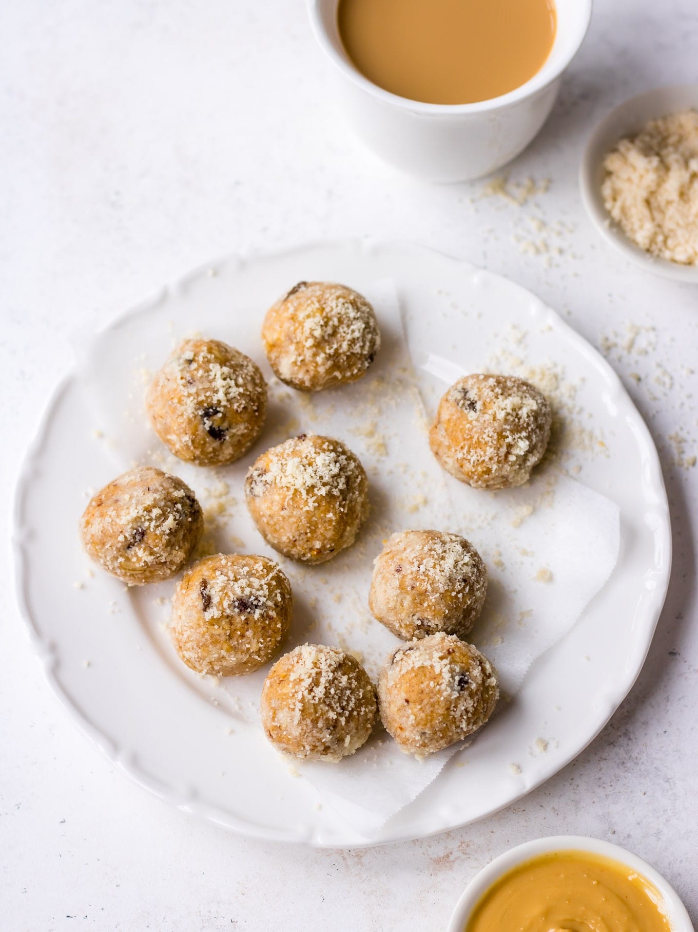 Energy bites for lactation on a small plate, served with a cup of tea
